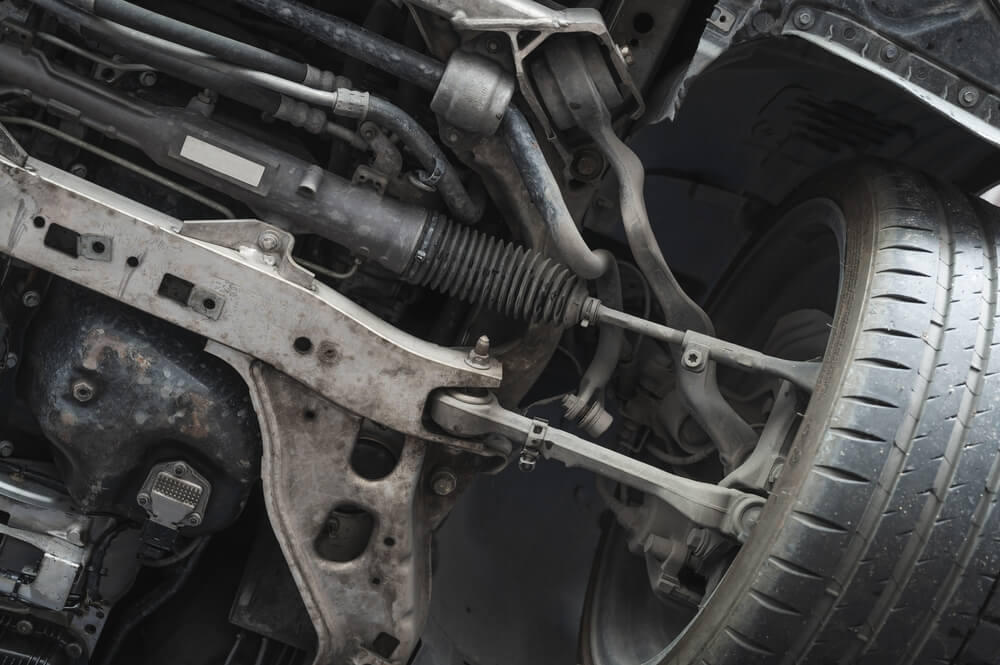 Close-up of car front suspension and steering system components