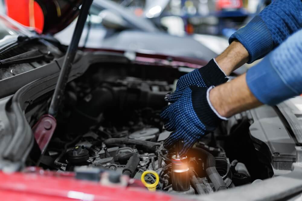 Mechanic repairing a car engine in the workshop